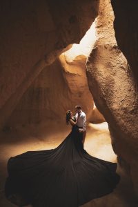 Couple photoshoot in Cappadocia — bold dress and neutral outfit combination
