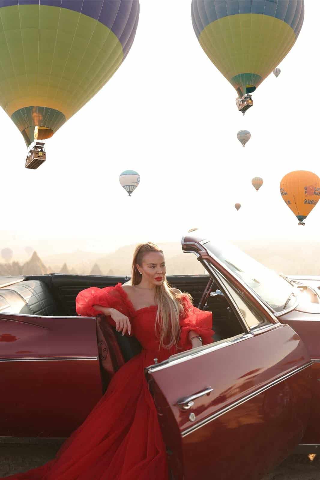 Red dress photoshoot with a vintage classic car in Cappadocia