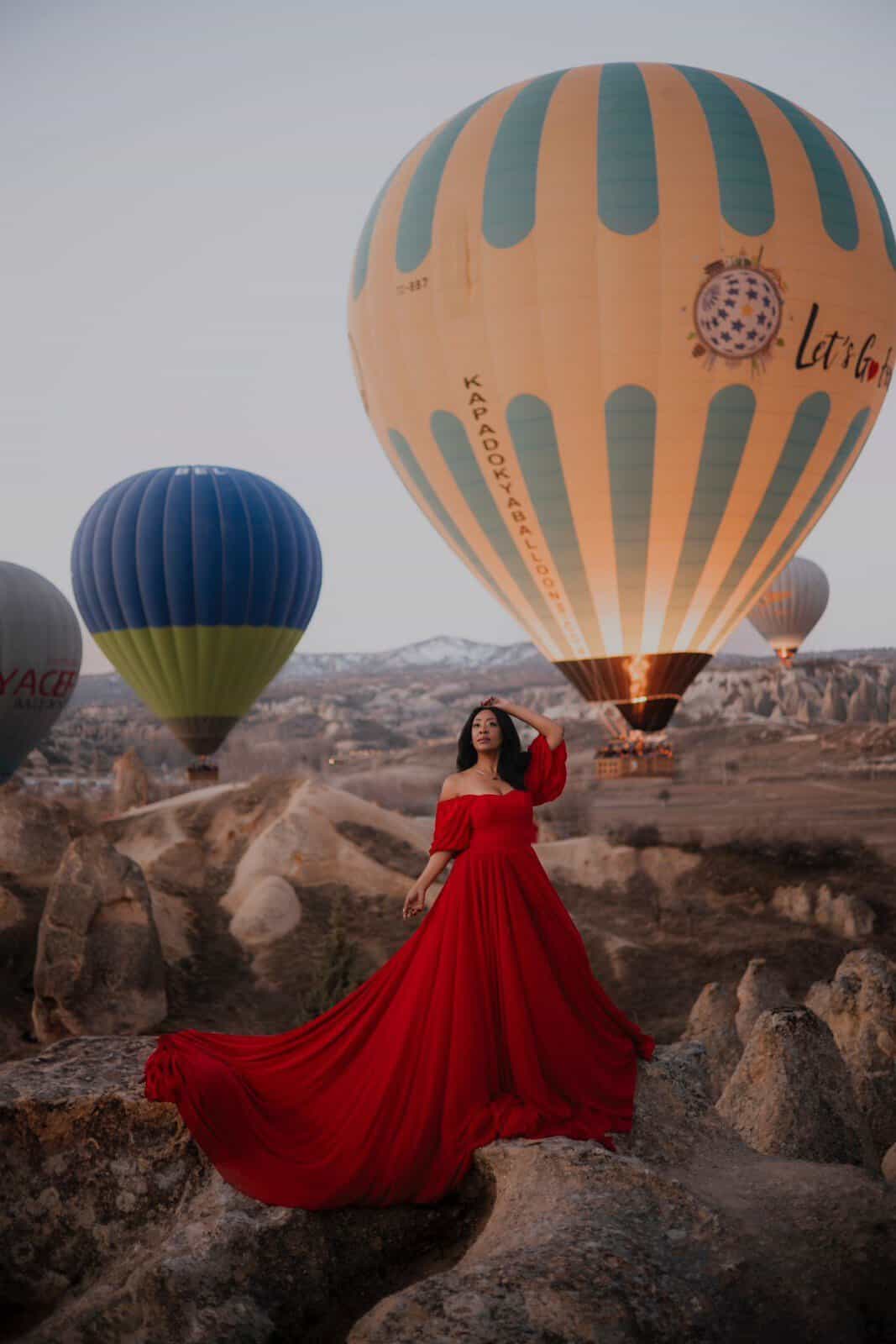 Flying dress photoshoot at sunrise with a hot air balloon in Cappadocia
